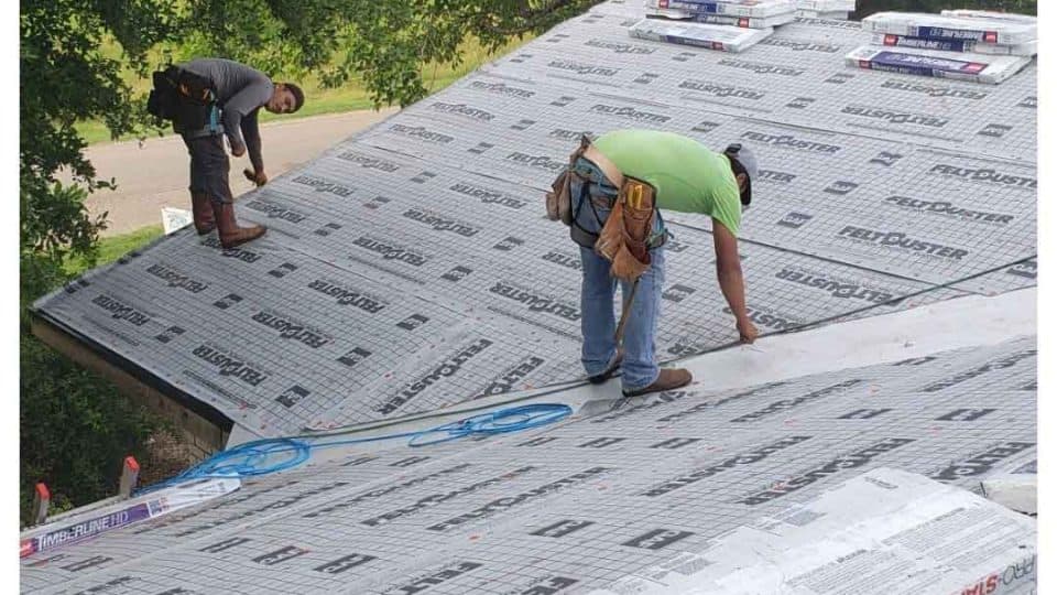 Amos Roofing crew repairing a roof